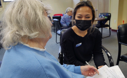 Suki Liang assists a respondent filling out the survey at the Salvation Army in Portland