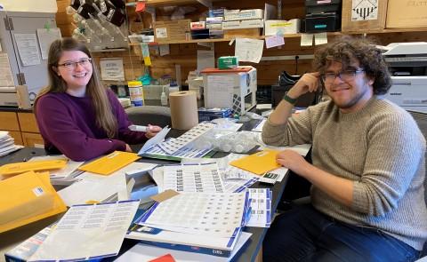 UNE student Brooke Parks sits with MDI Biological Laboratory independent study student, Adam Feher.